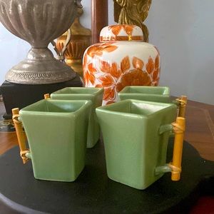 Green, ceramic espresso cups with bamboo handles.